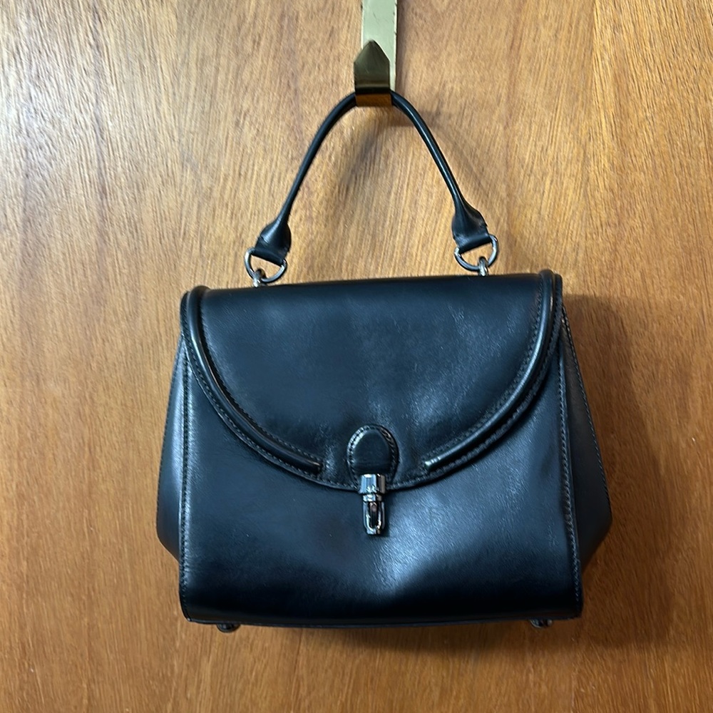 Leather satchel with detachable shoulder strap.